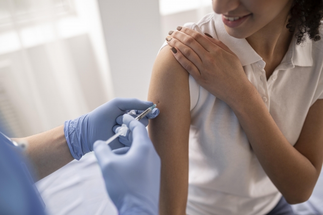 doctor vaccinating patient clinic